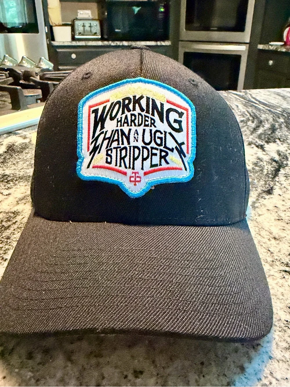 Black Cap with 'Working Harder Than A Ugly Stripper' Patch